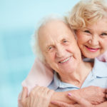 Elderly couple holding each other