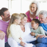 Family sitting indoors smiling