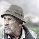 Elderly man's face over white background